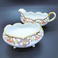 Vintage Hand-Painted Porcelain Cream and Sugar Set With Feet And Gold Guilding